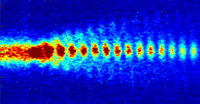 Proton bunches in sync: A train of short proton bunches travels through the plasma field, forming a wave on which electrons can be accelerated. (Image: AWAKE)