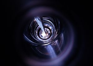 Preparation of the GERDA experiment: Lowering the germanium detector array into the liquid argon tank  - view from top. (photo: M. Heisel/GERDA collaboration)