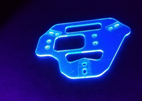 PEN holder for the Germanium detectors in the LEGEND-200 experiment. The plate is illuminated in blue when exposed to UV light. (Photo: L. Manzanillas/MPP)