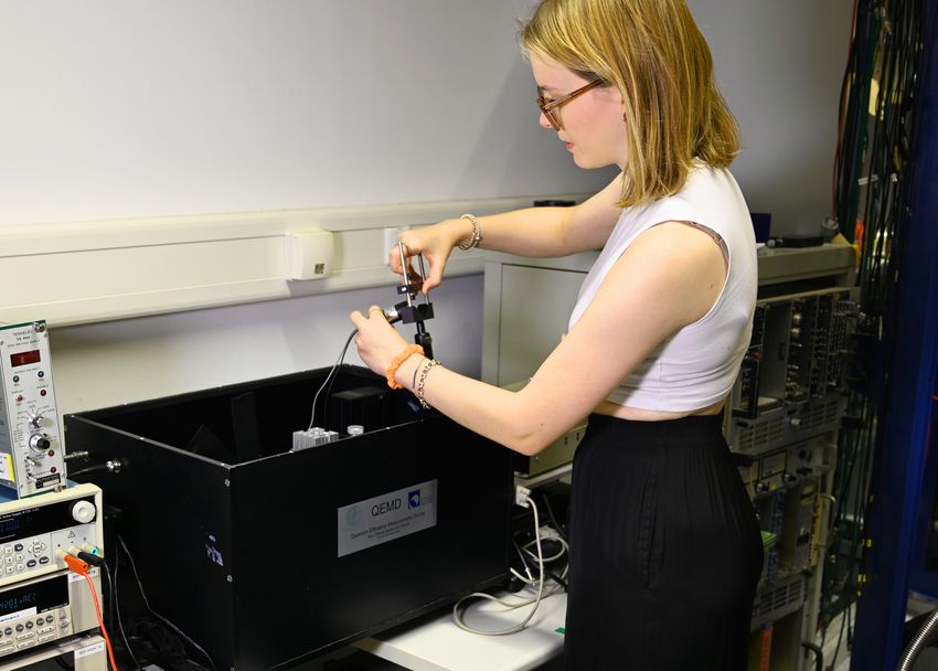 Julia Summerer attaches a photomultiplier to the holder. (Photo: Felix Schmuckermaier/MPP)