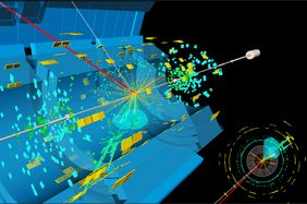 Die Aufnahme zeigt einen Kandidaten für die Produktion eines Higgs-Bosons, das in zwei B-Quarks zerfällt. Dabei entstehen auch ein W-Boson, das in ein Myon (rot) zerfällt sowie ein Neutrino.